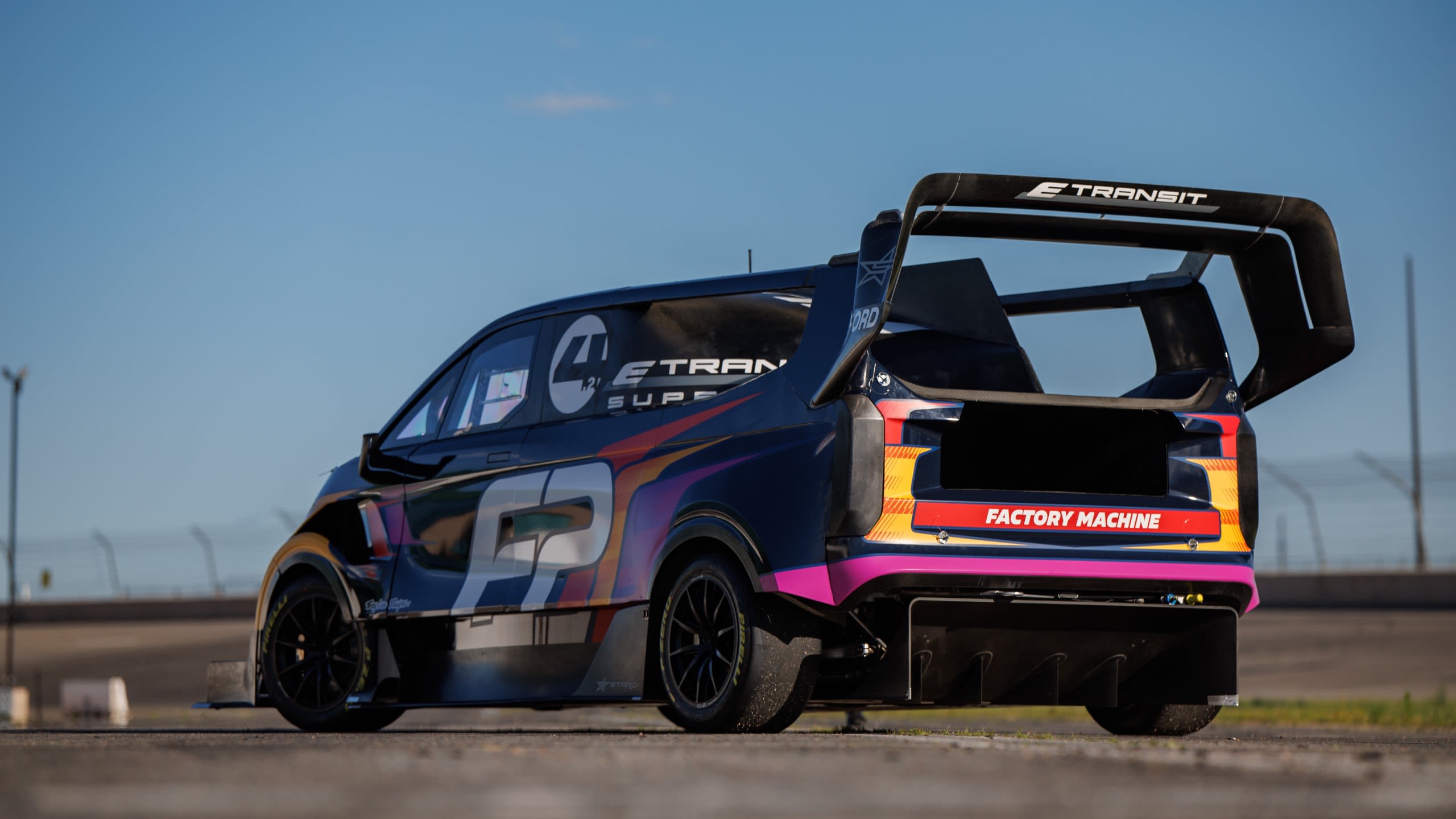 Rear view of Electric Supervan 4.2 showing crazy levels of aerodynamic design and bright livery