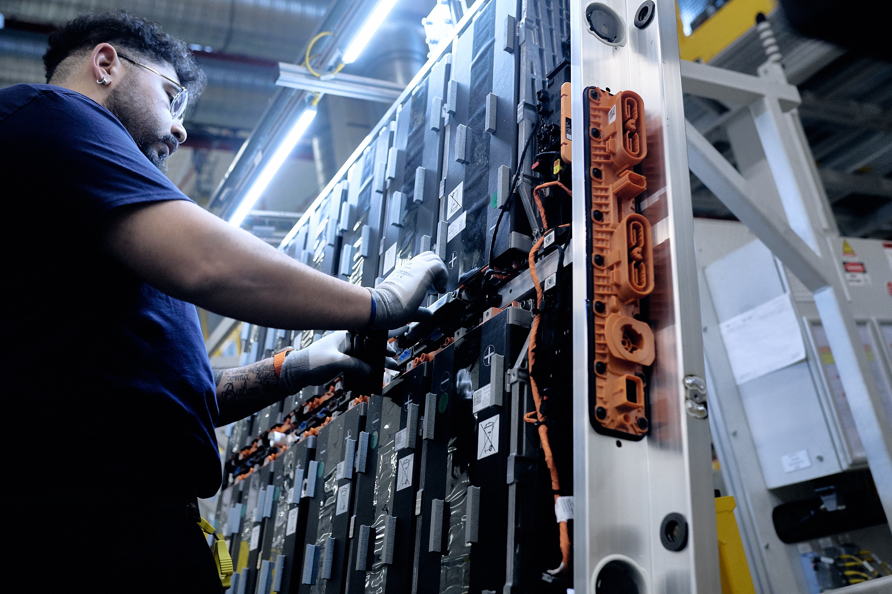 A Ford employee works on a battery pack at the Ford Cologne Battery Plant