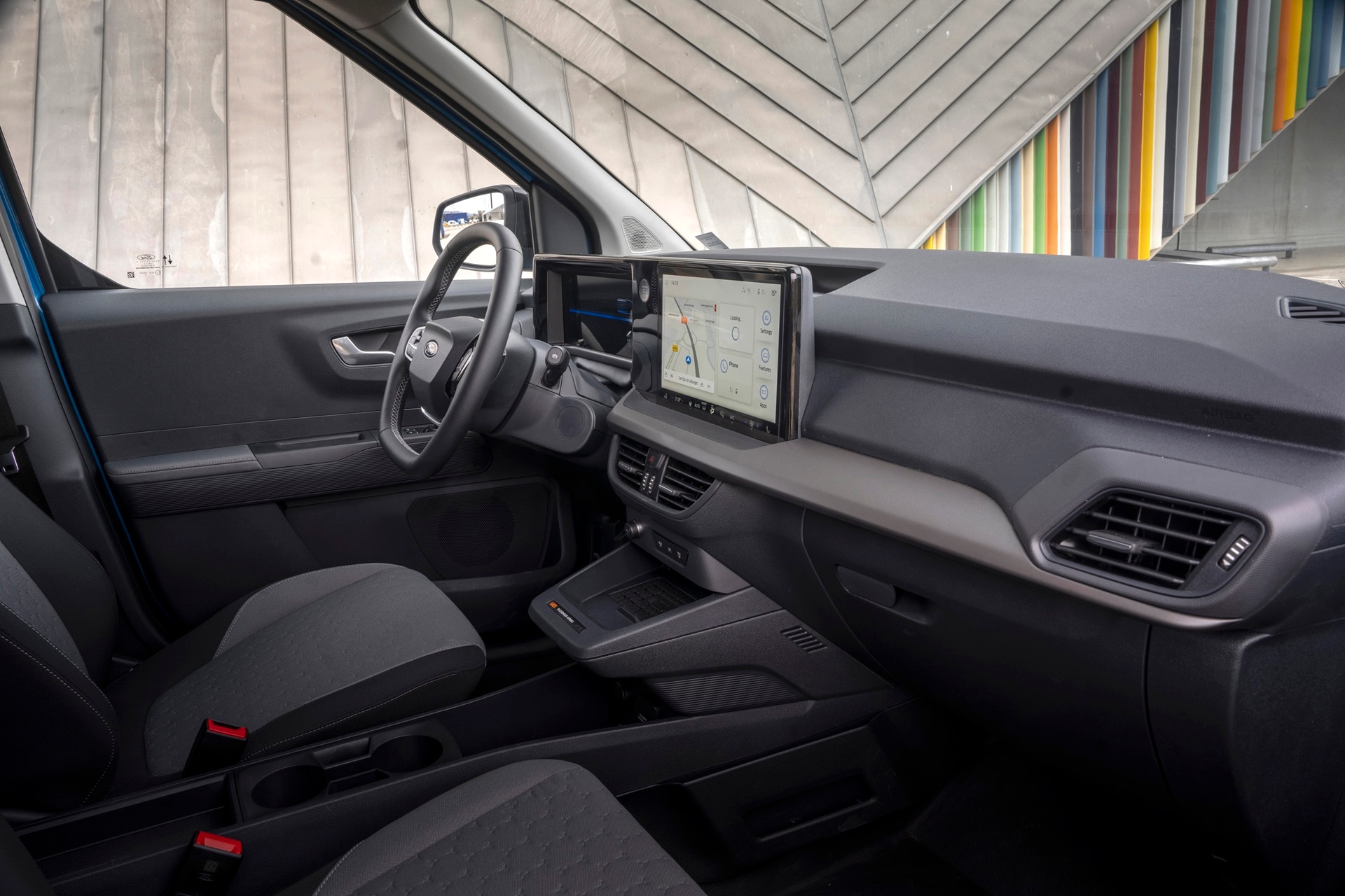View across spacious cab and storage of E-Transit Courier