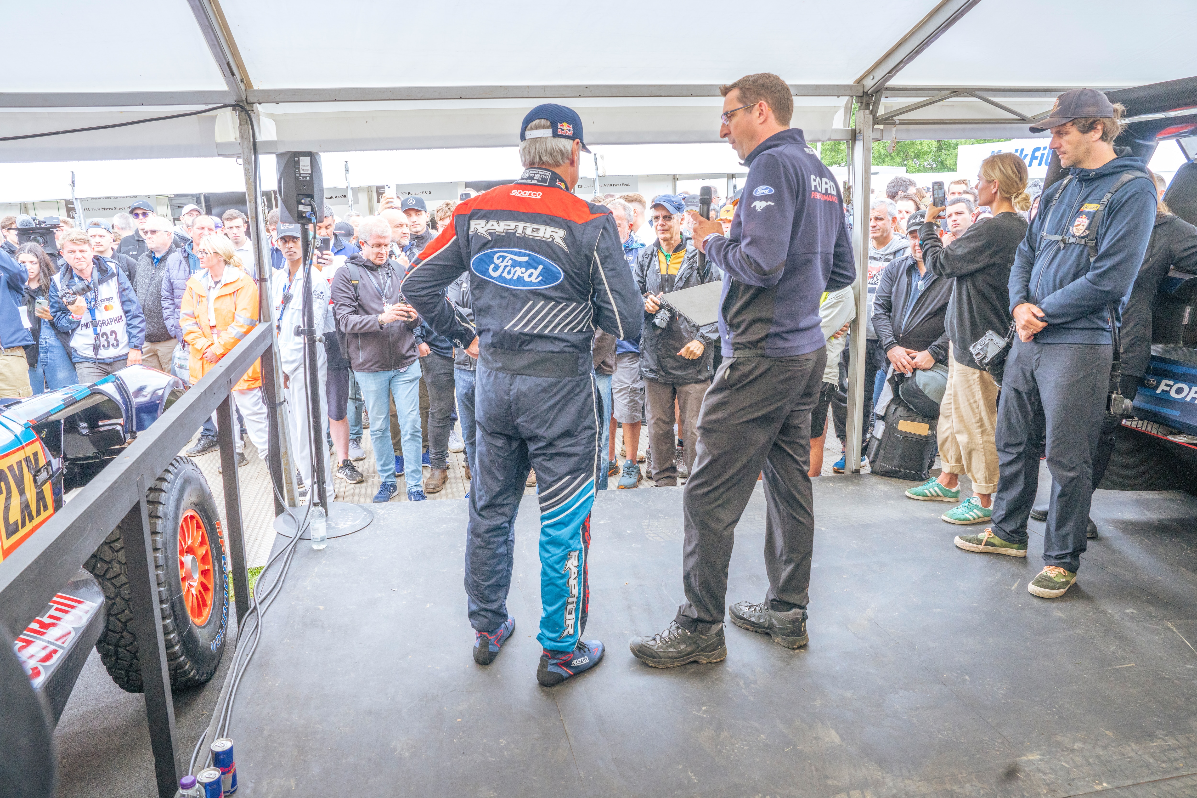 Ford's Jay Ward introduces rally legend Carlos Sainz at the 2024 Goodwood Festival of Speed. License valid for earned editorial, press releases, press kits. All non-broadcast digital and online media Region: Global. This content is solely for editorial use and for providing individual users with information. Any storage in databases, or any distribution to third parties within the scope of commercial use, or for commercial use is permitted with written consent from Ford in Europe GmbH only.