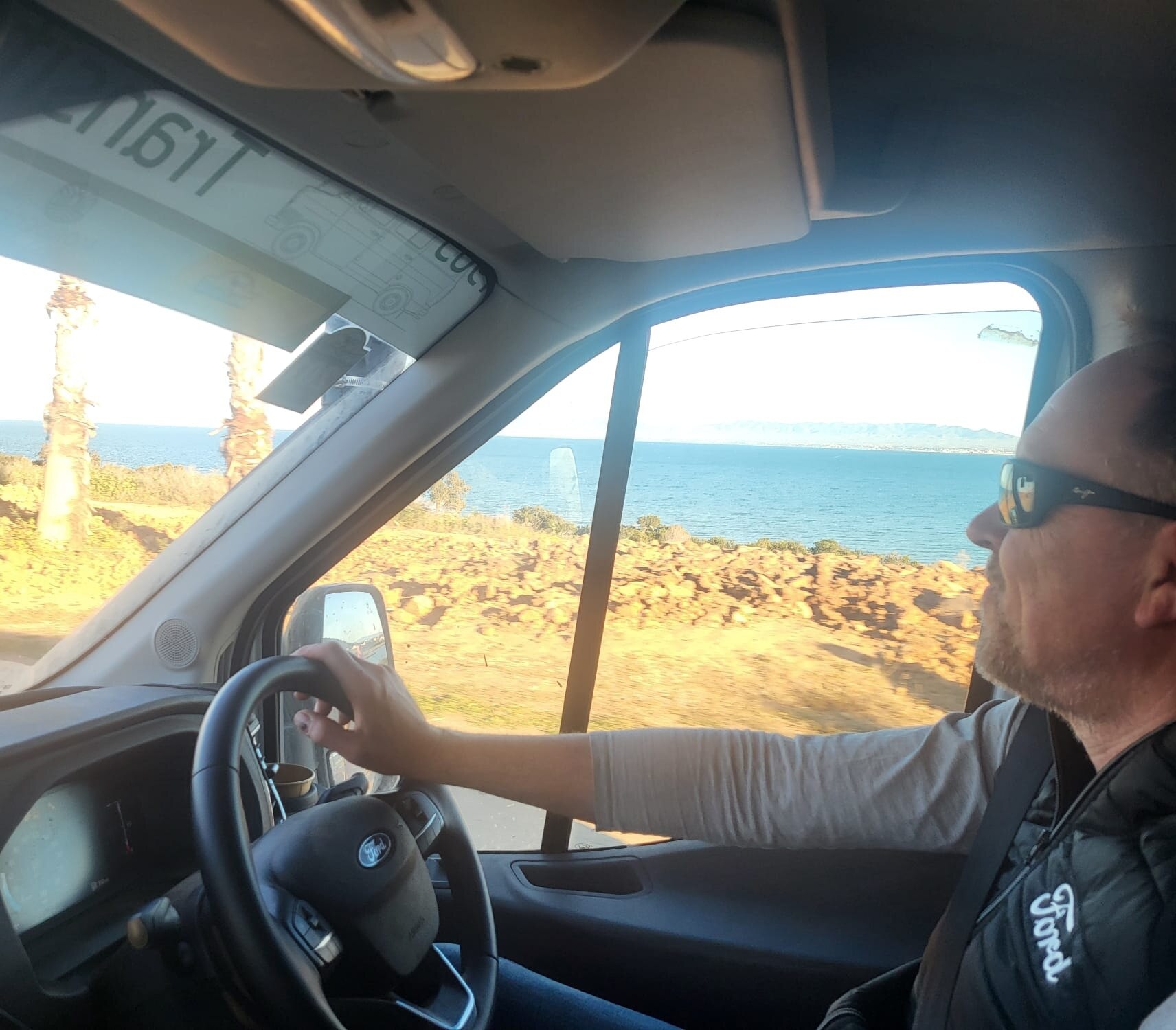 James driving as the team first see the Mediterranean