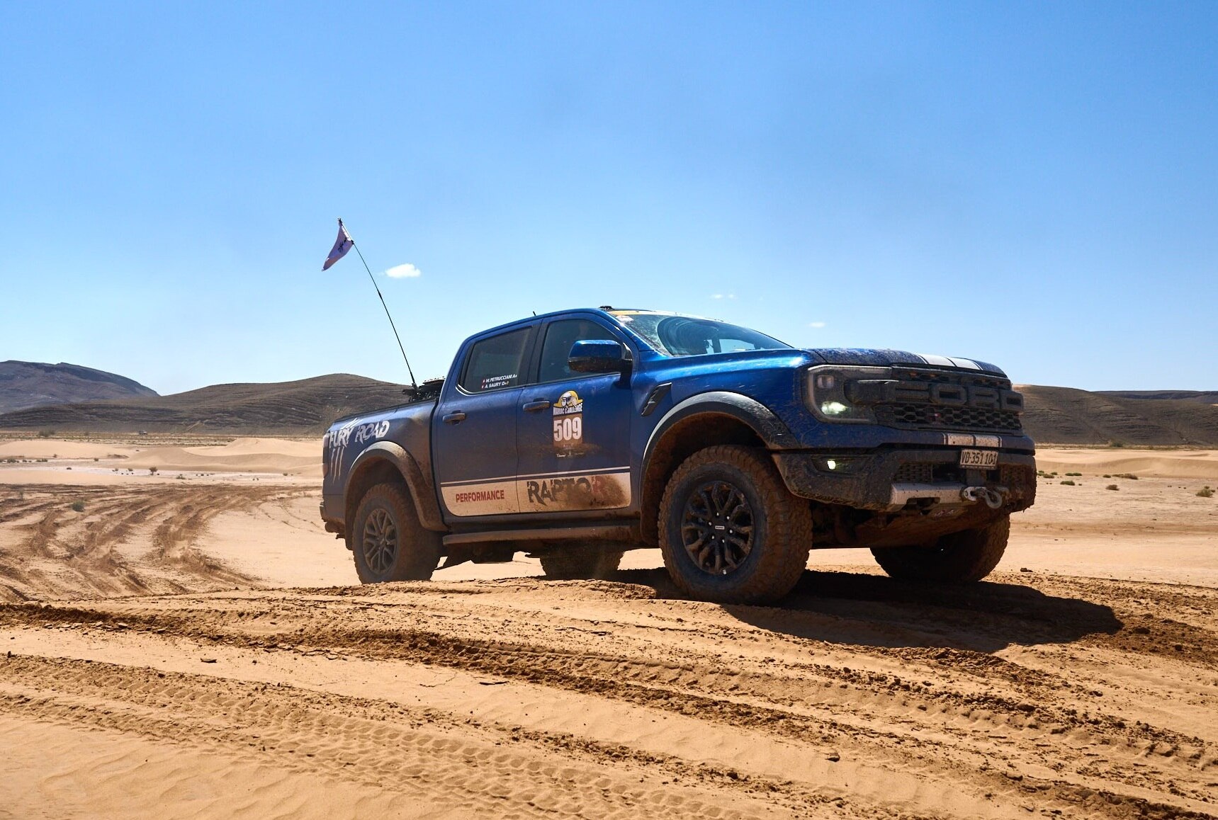 Ford Ranger Raptor driving through sand dunes