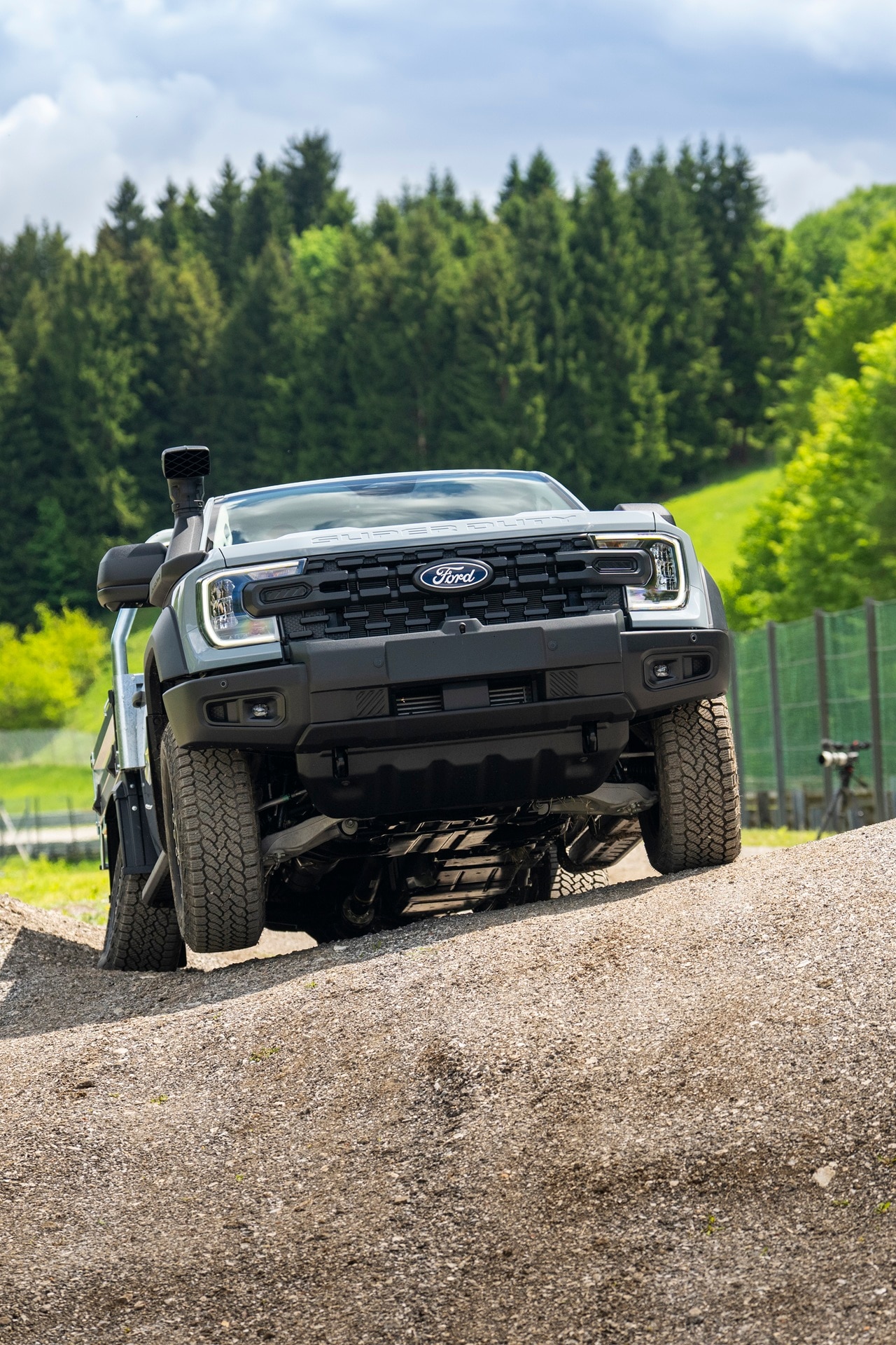 Ranger Super Duty climbing steep hill with forest in background