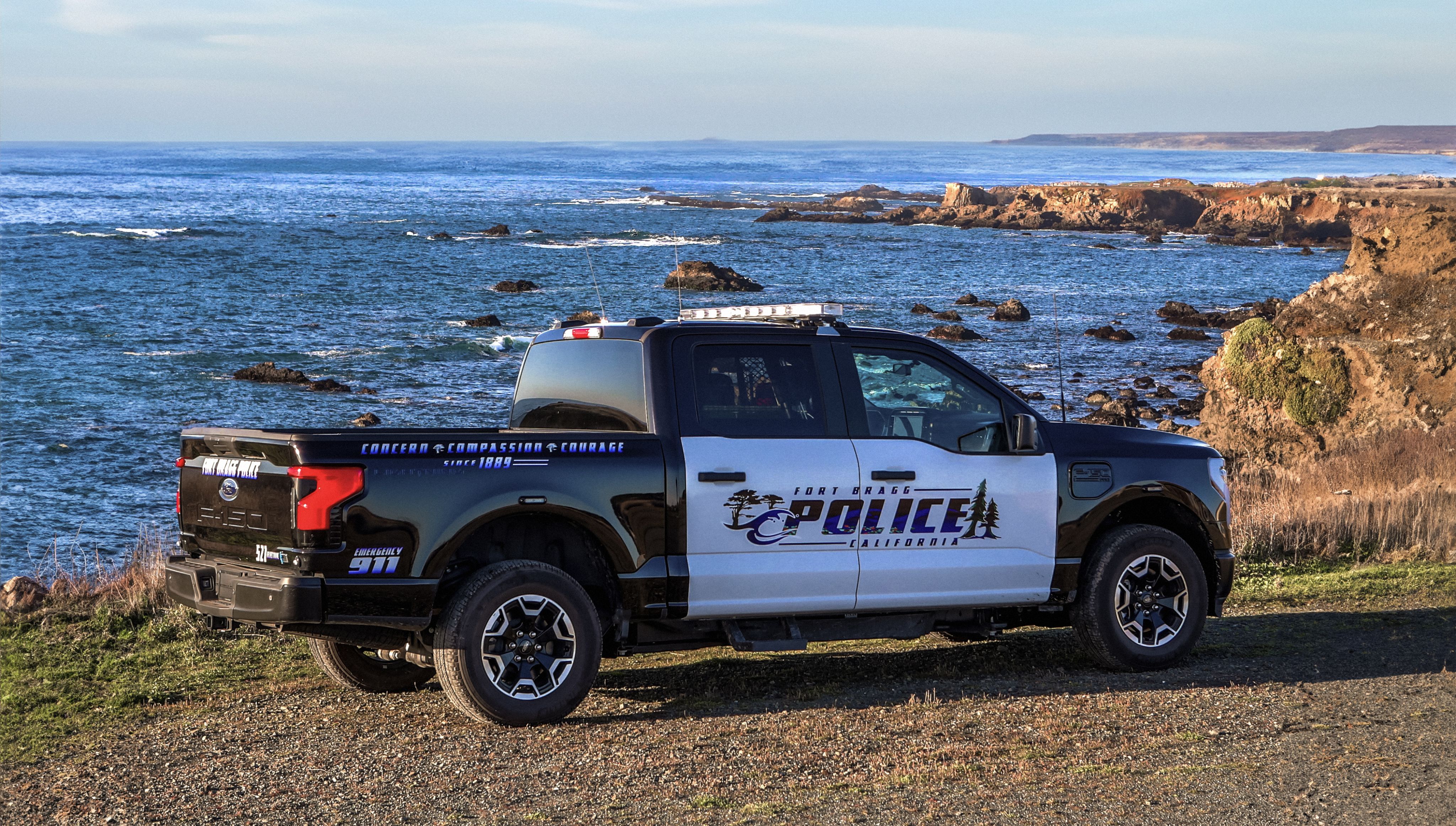 A Fort Bragg Police Department F-150® Lightning® Pro Special Service Vehicle parked along the California coastline.
