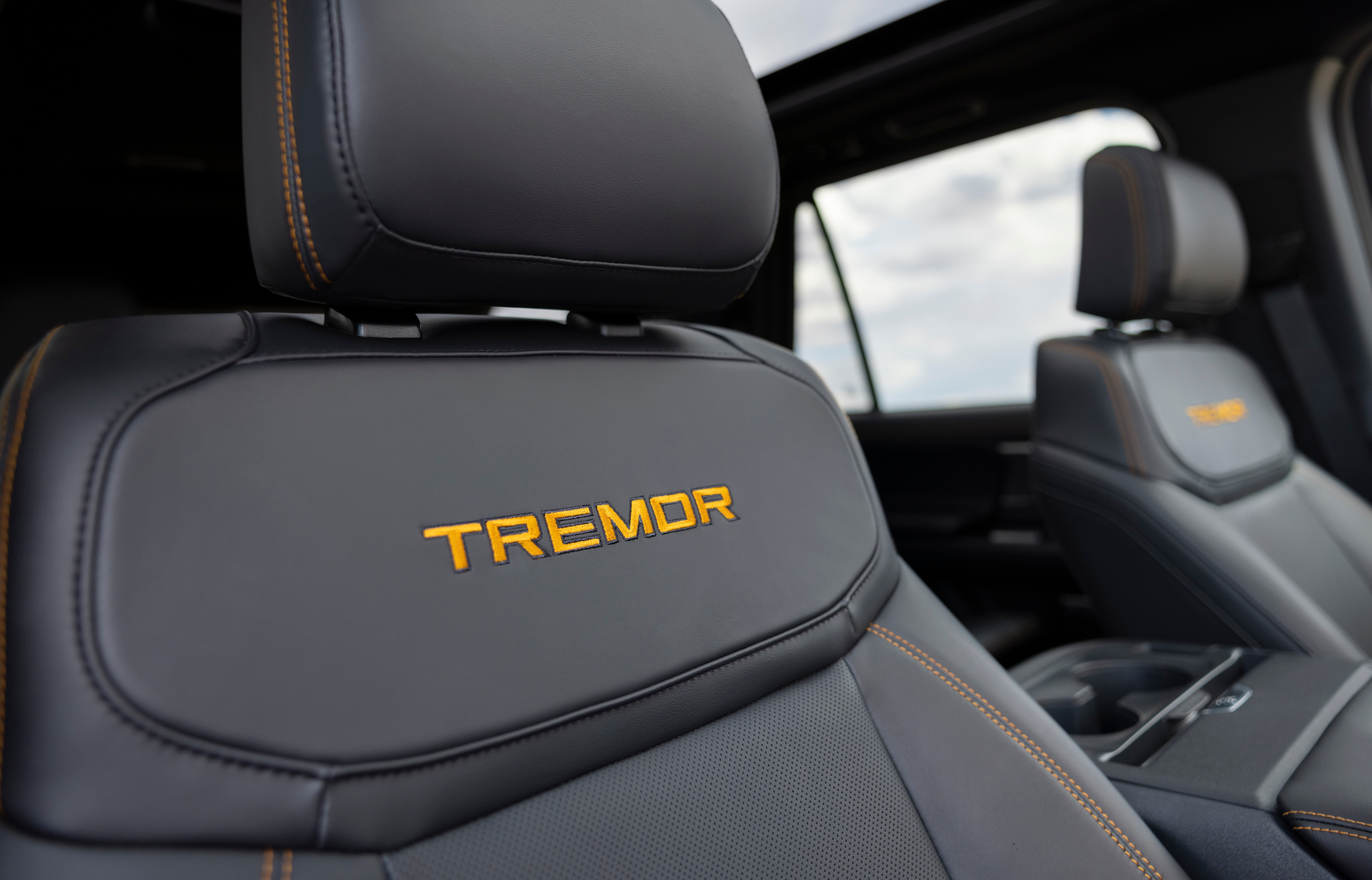 2025 Ford Expedition Tremor interior seat shown with the word "TREMOR" in yellow letters on a dark gray seat.