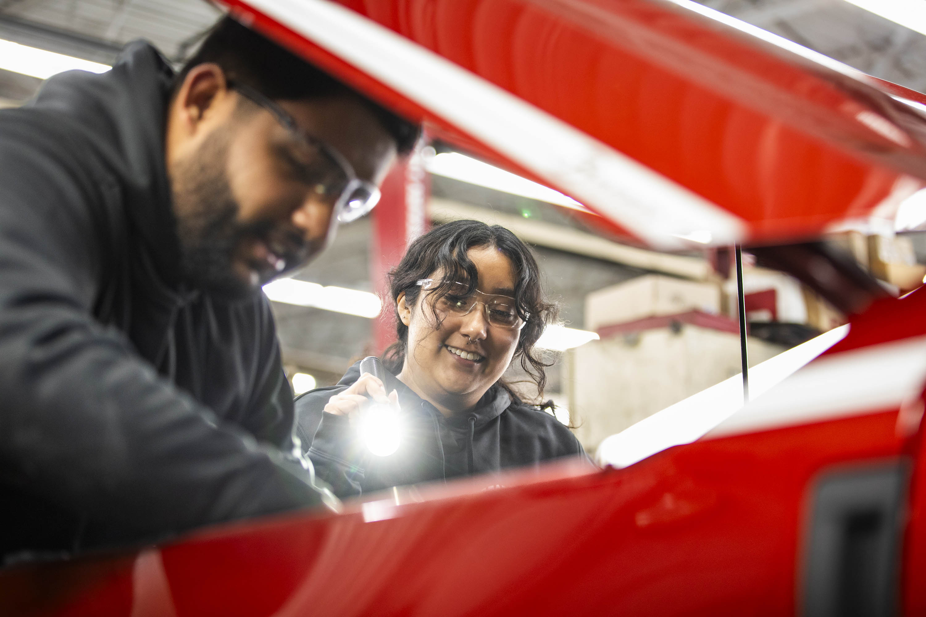Mustafa Alhefady and Keiry Perez-Ruiz, auto tech scholarship recipients, at Varsity Ford in Ann Arbor, Michigan.