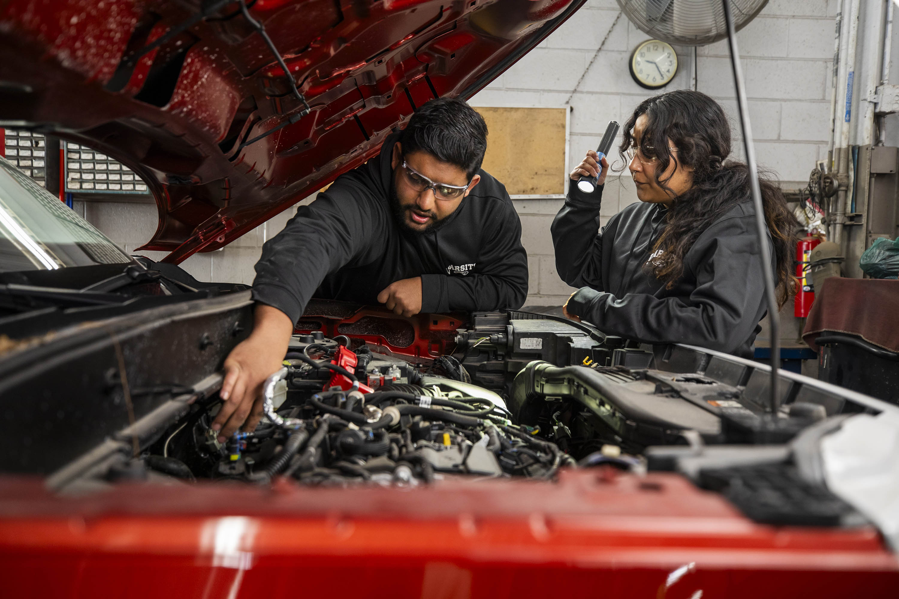 Mustafa Alhefady and Keiry Perez-Ruiz, auto tech scholarship recipients, at Varsity Ford in Ann Arbor, Michigan.