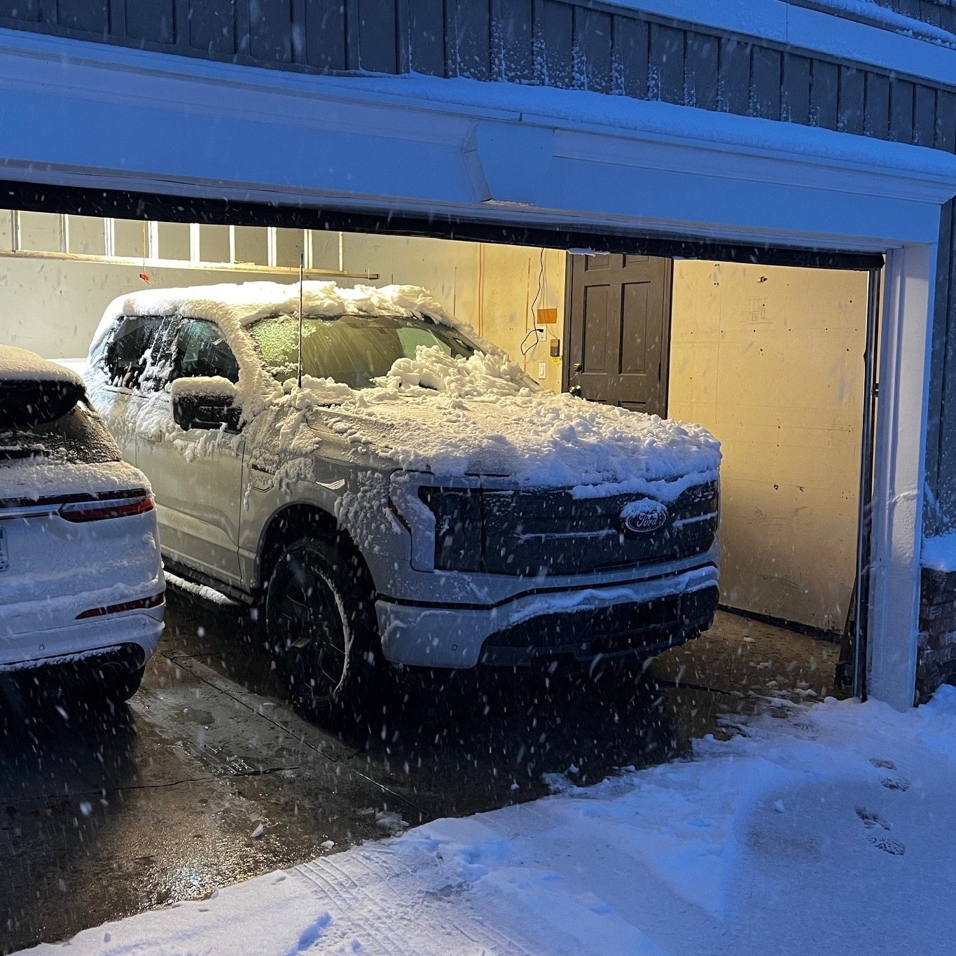 Jim's snow-covered F-150 Lightning charging in the garage.