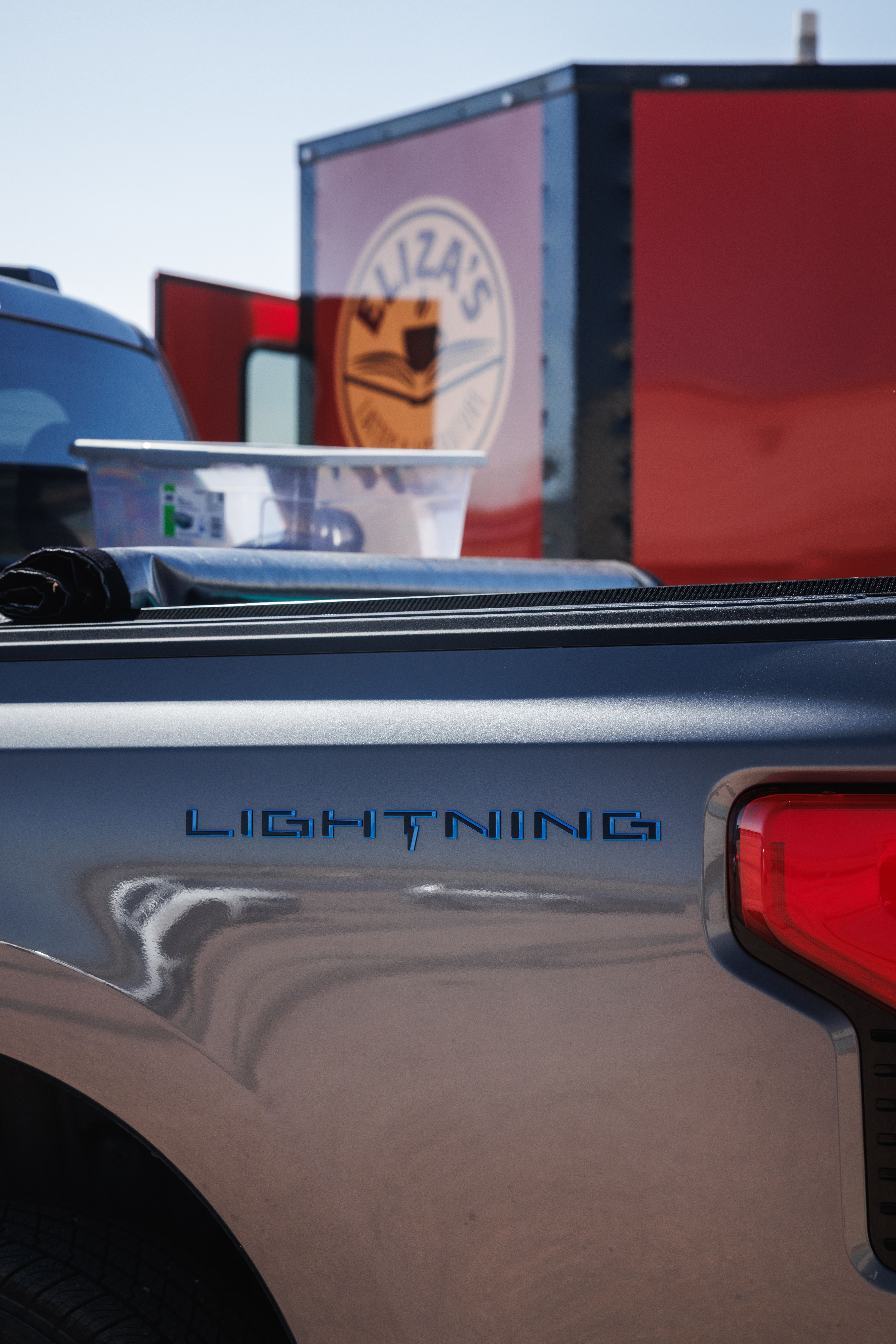 Eliza's F-150 Lightning in front of her trailer.