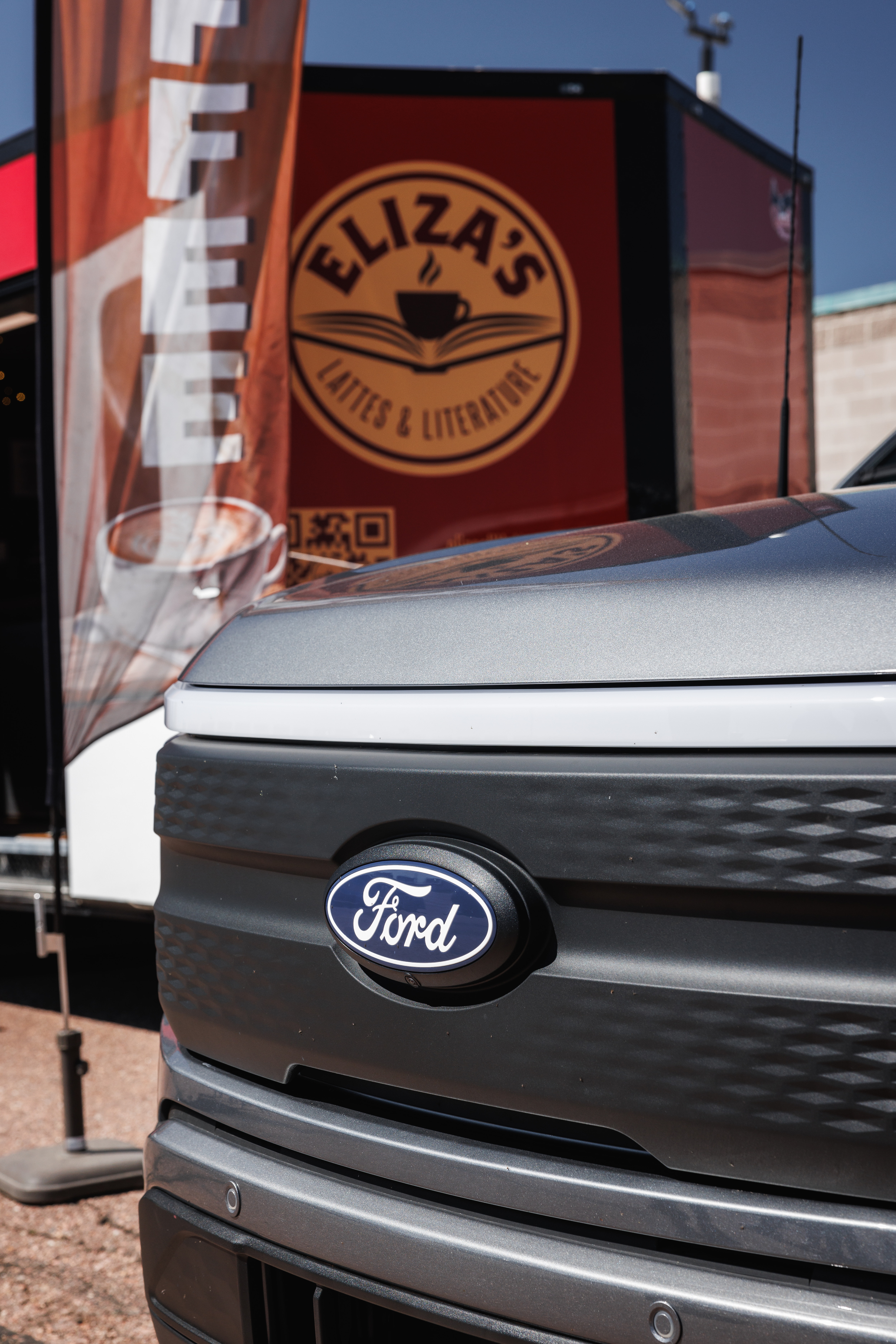Eliza's F-150 Lightning in front of her trailer.