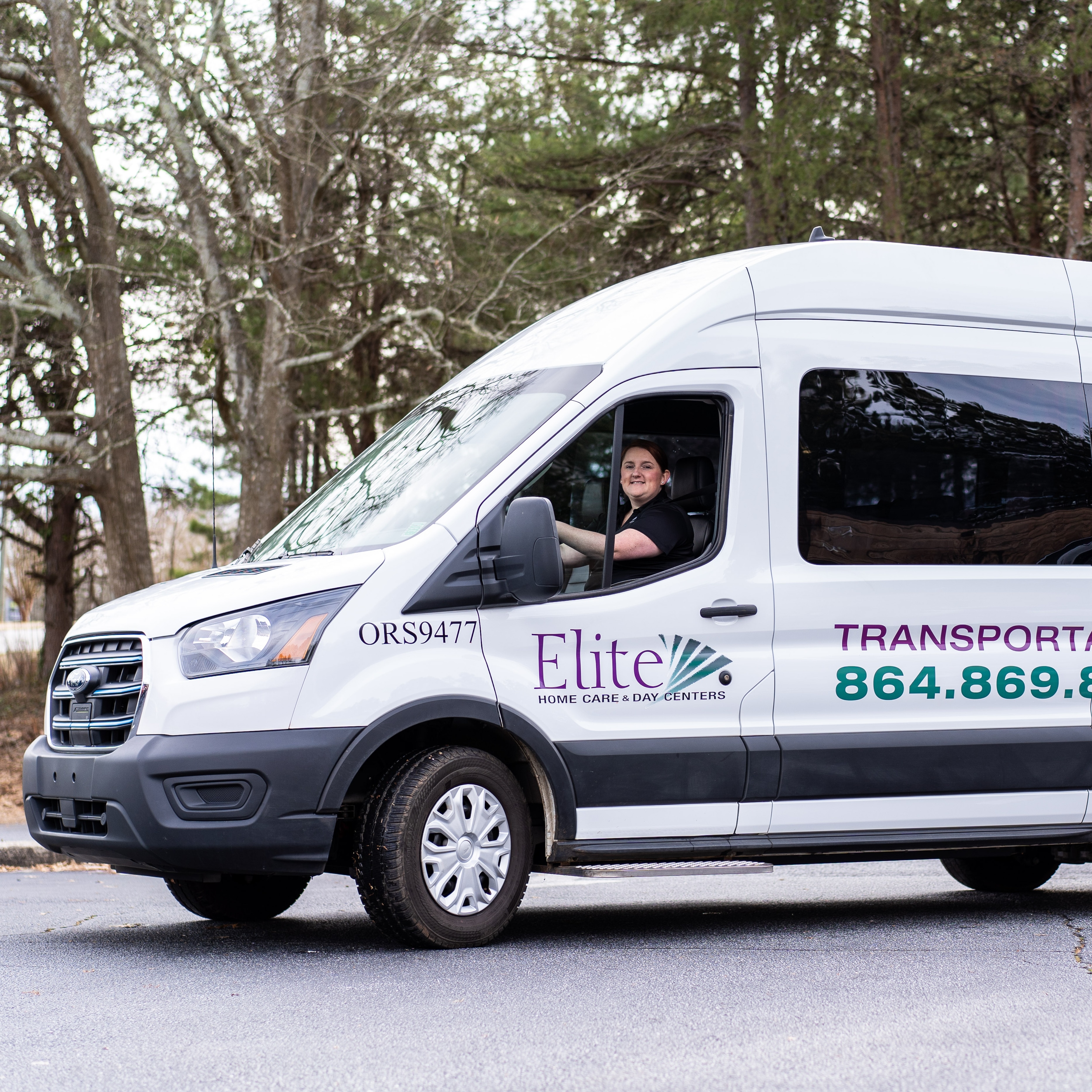 A driver behind the wheel of one of Elite Home Care's E-Transit vans.