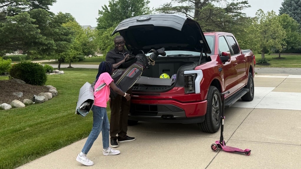Dapo Adewusi, vehicle engineering manager for both the Mustang Mach-E and the F-150 Lightning, uses the Mega Power Frunk to help with his children's activities.