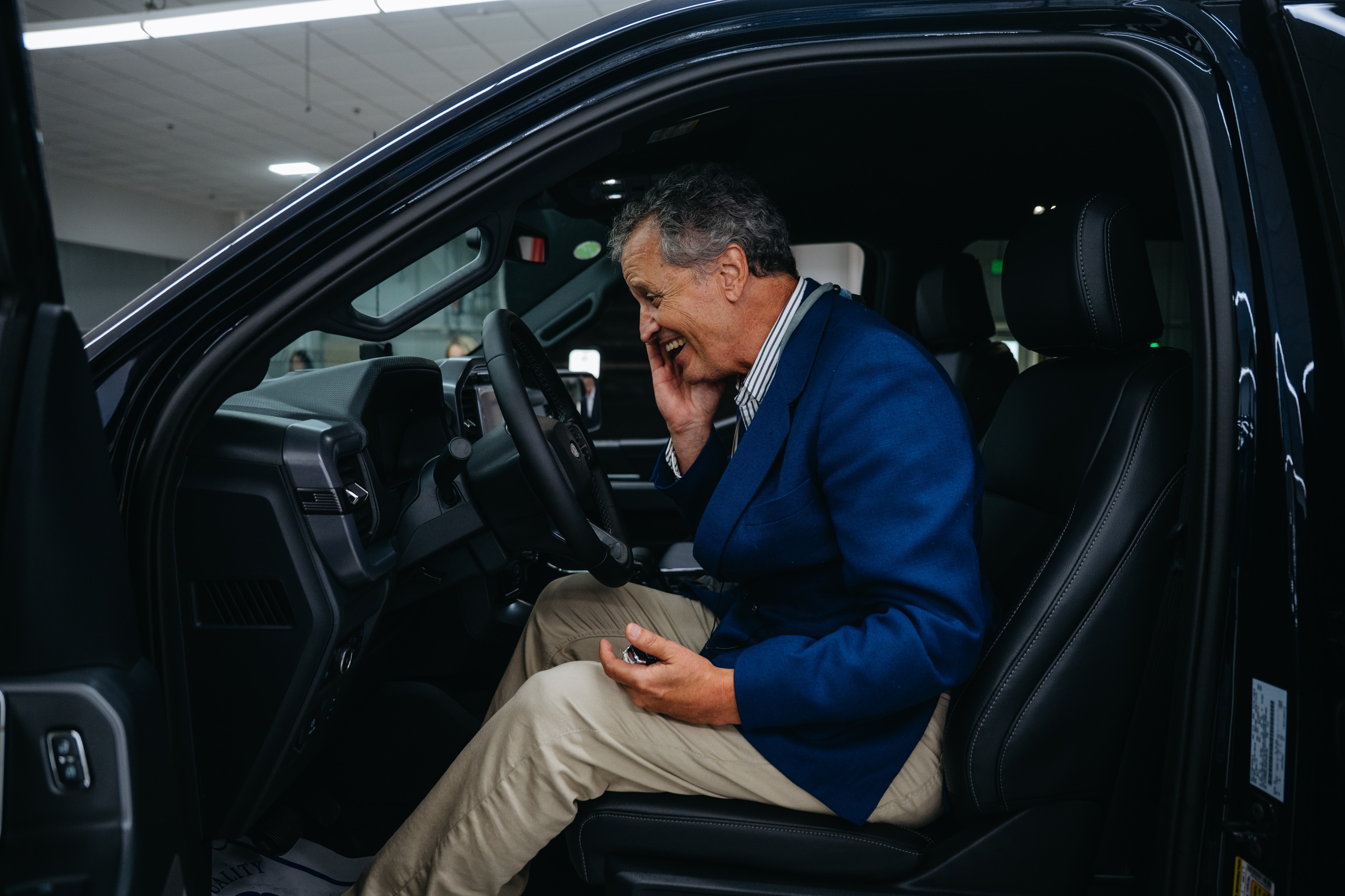 Marc Fogel reacts to sitting in his new Ford F-150 truck for the first time at Dearborn Truck Plant on Monday, May 5, 2025. The truck was a surprise gift from Shults Ford as a welcome home gesture for Fogel, an American history teacher who recently returned home after being wrongfully detained in Russia. (Optional equipment shown.)