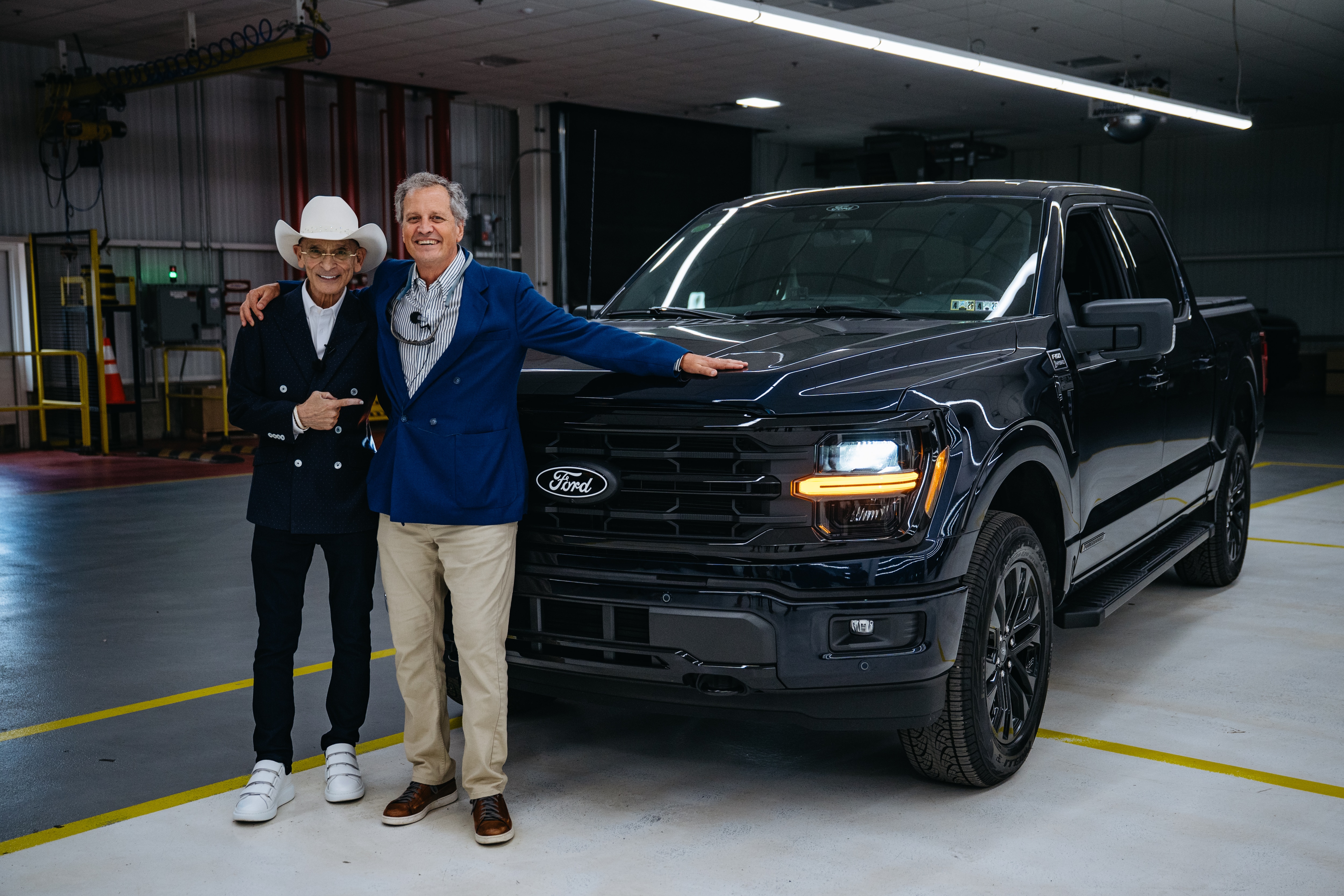 Marc Fogel poses alongside Richard Bazzy, owner of Shults Ford and Shults Lincoln in Pennsylvania, with his new Ford F-150 truck after being surpirsed with the gift from Shultz Ford at Dearborn Truck Plant on Monday, May 5, 2025. The truck was a surprise gift from Shults Ford as a welcome home gesture for Fogel, an American history teacher who recently returned home after being wrongfully detained in Russia. (Optional equipment shown.) 