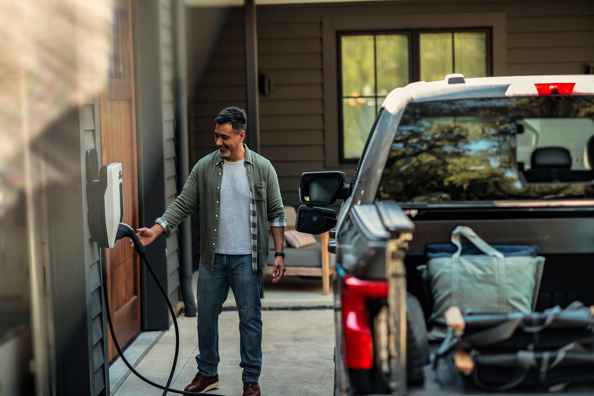 A man charges his electric vehicle.