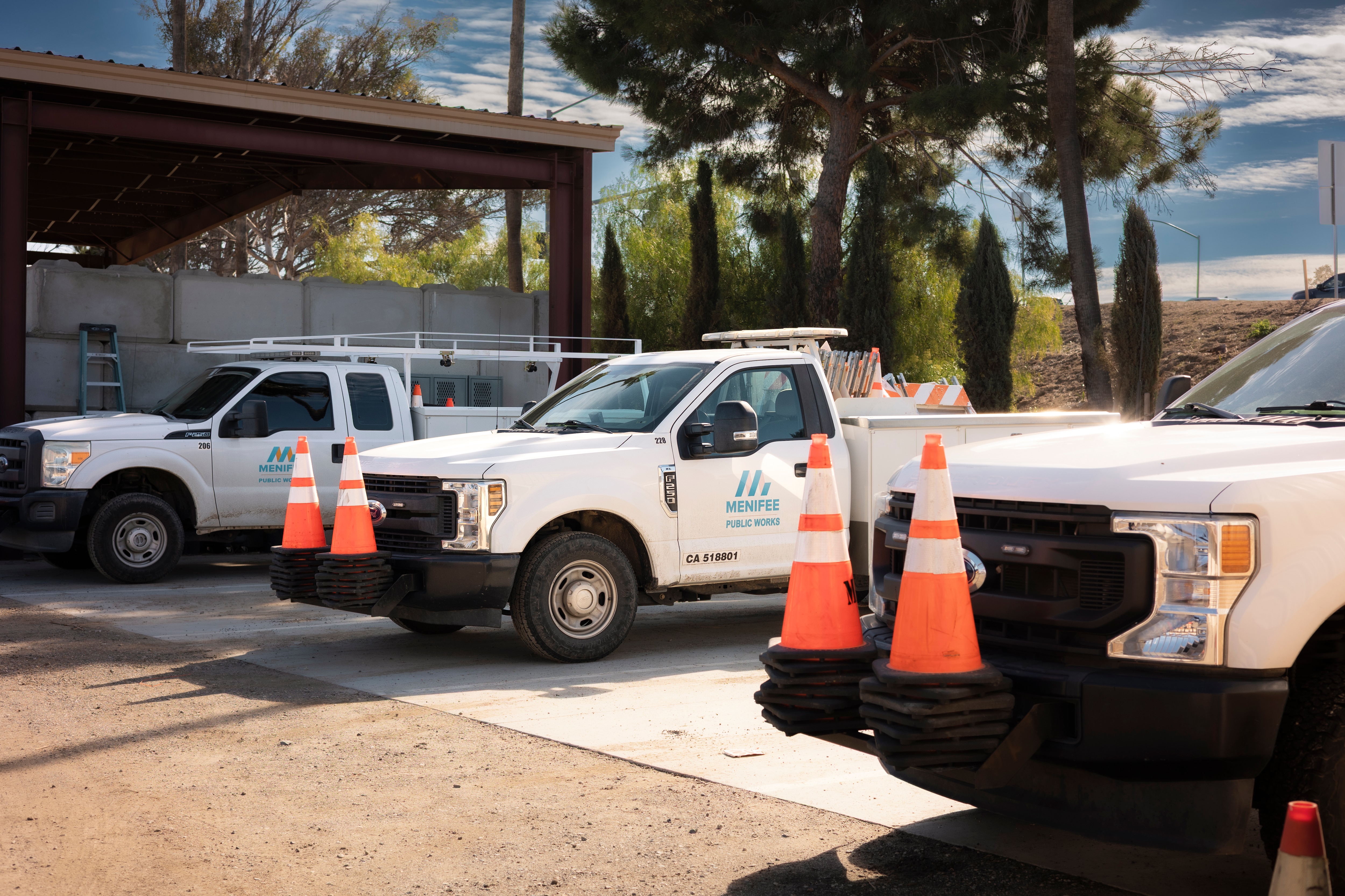 Three City of Menifee Ford trucks parked in a row.