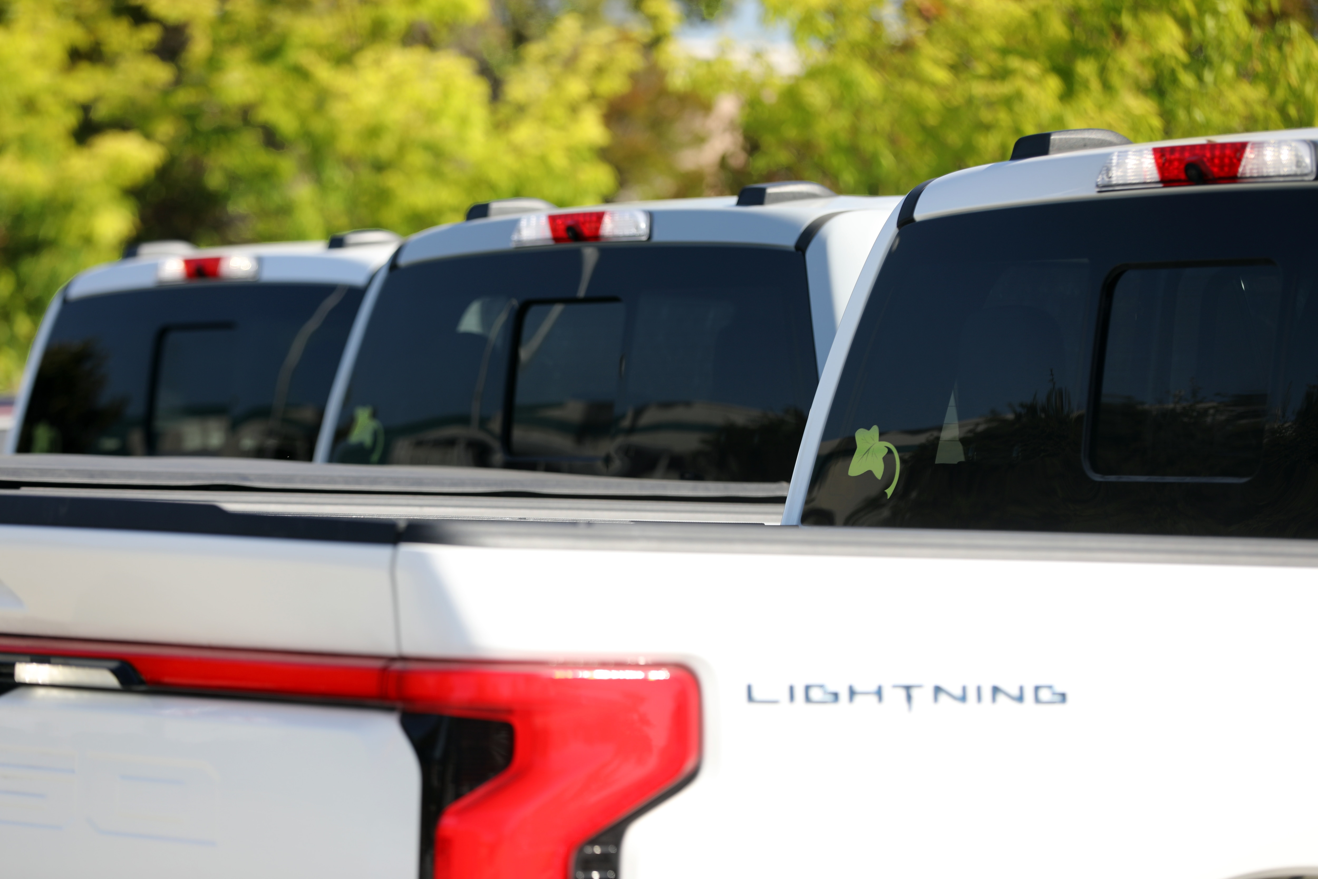 Two F-150® trucks and an F-150® Lightning® truck parked side by side. 