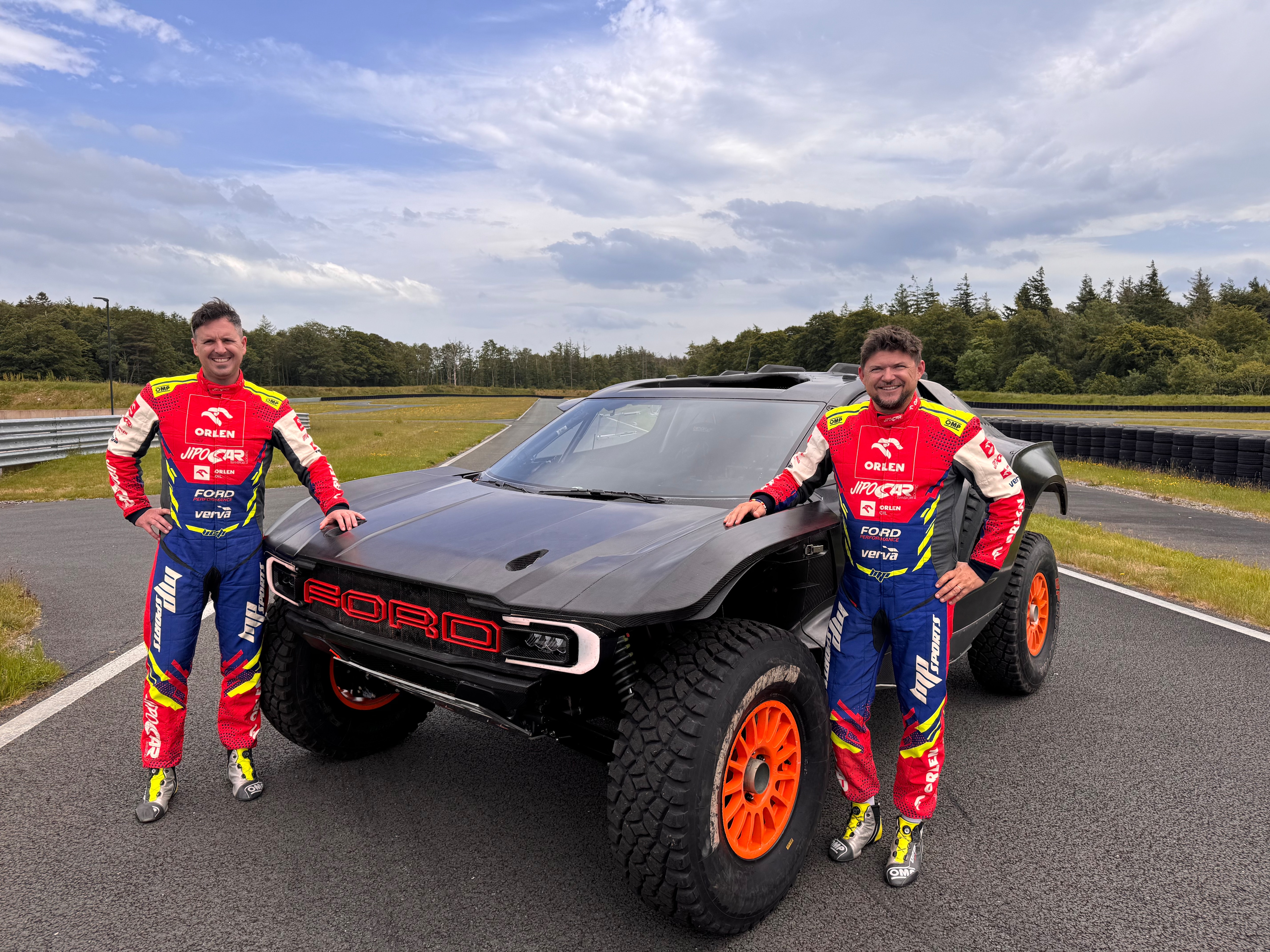Navigator/co-driver Viktor Chytka (left) and driver Martin Prokop (right) on the grounds of M-Sport with their Ford Raptor T1+.