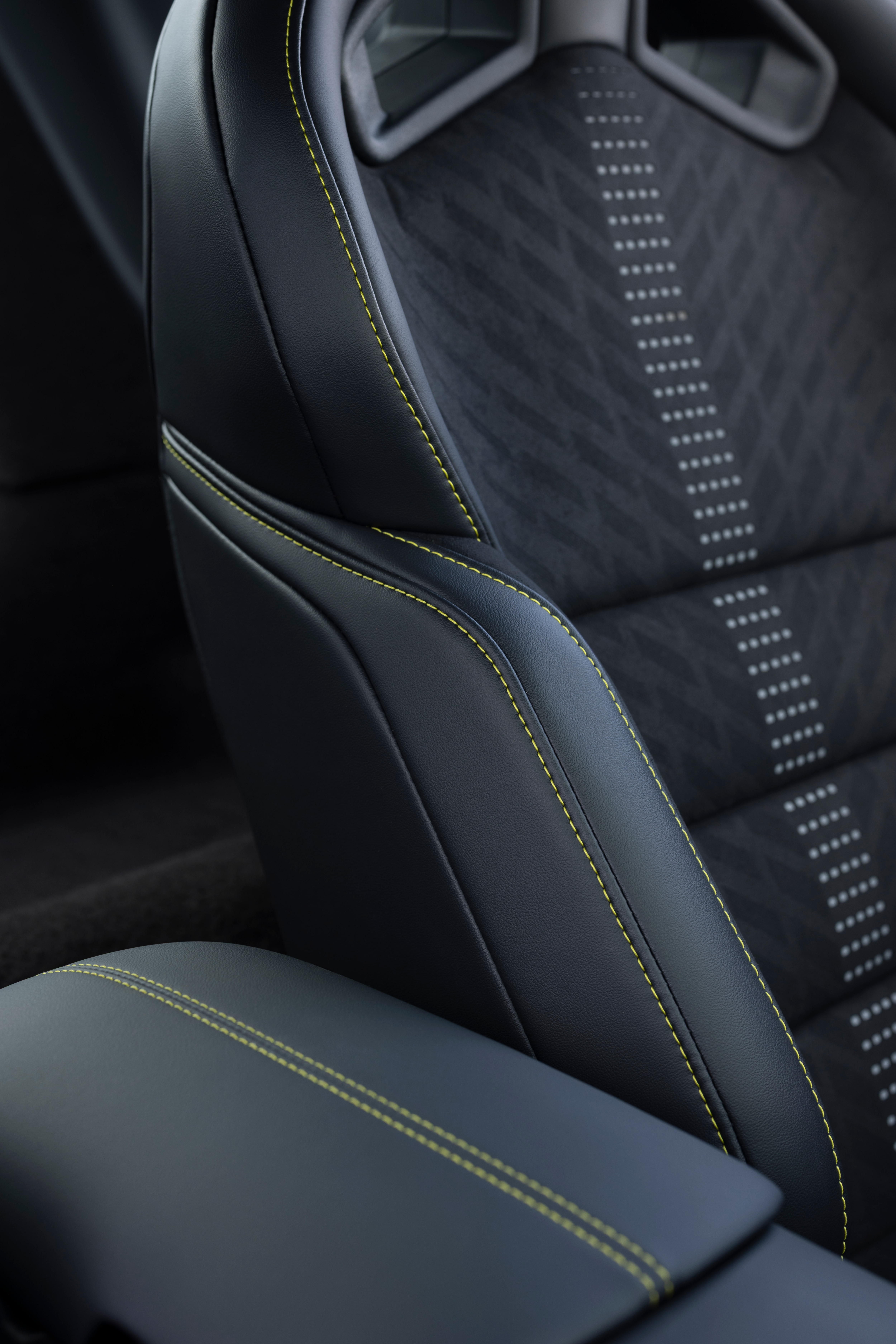 New Mustang Liquid Carbon interior shows lime green stitching on black and grey interior fabric.