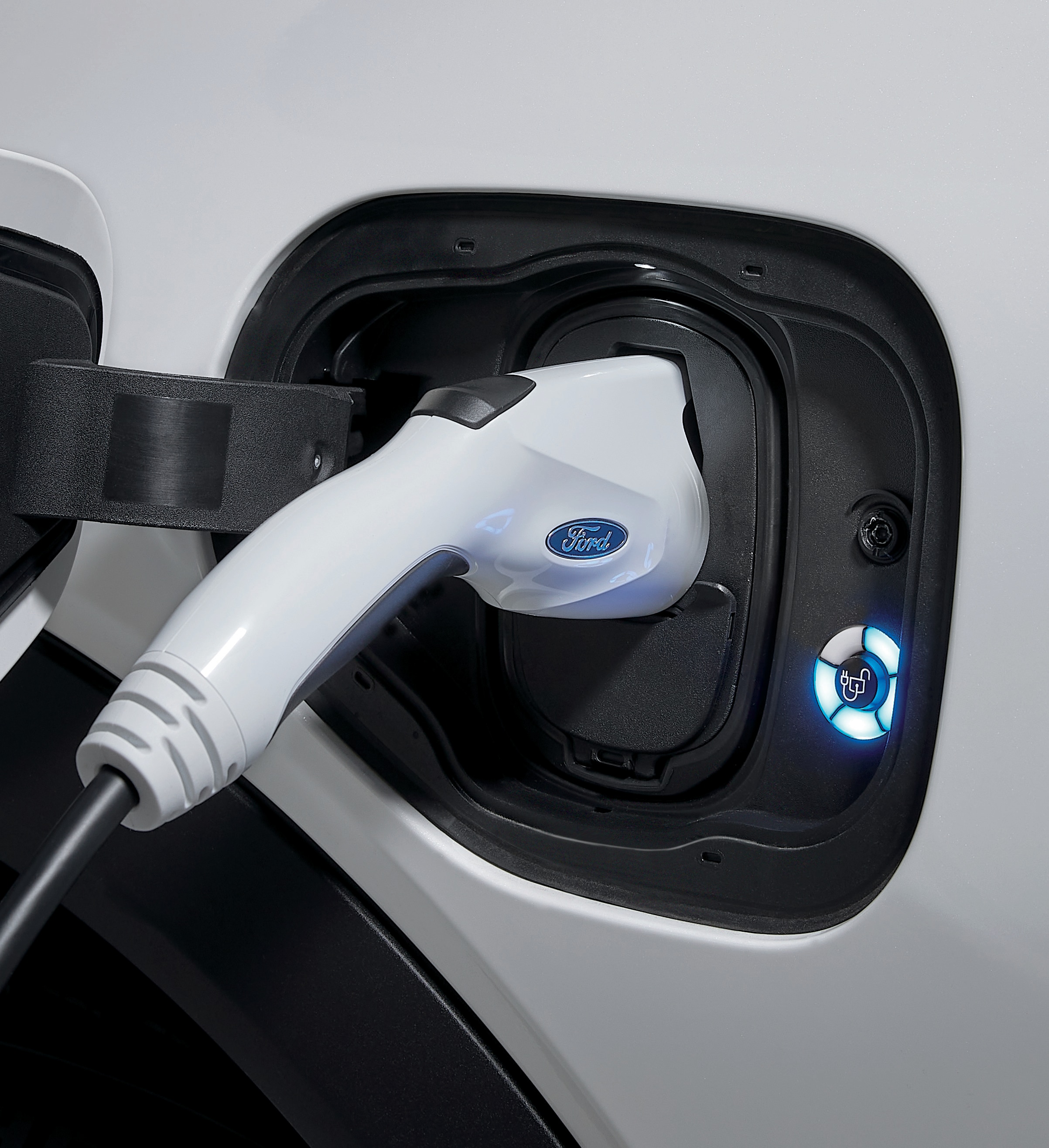 A Ford Pro electric vehicle charger plugged into a vehicle